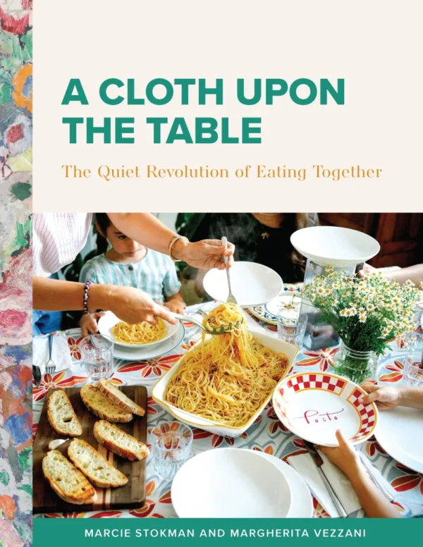 Cover of A Cloth Upon the Table: a family passing bowls of pasta around a set table, with a painterly floral border down the spine.